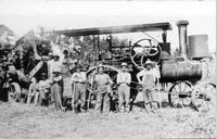 John Martin (right) by threshing machine